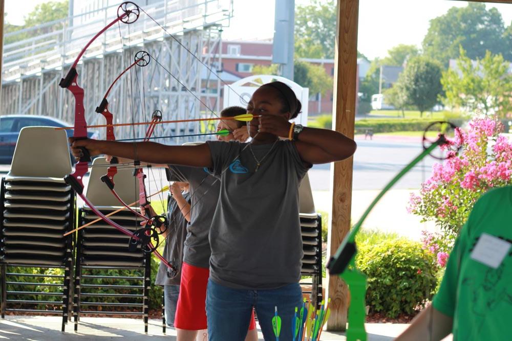 Female kid shooting an arrow